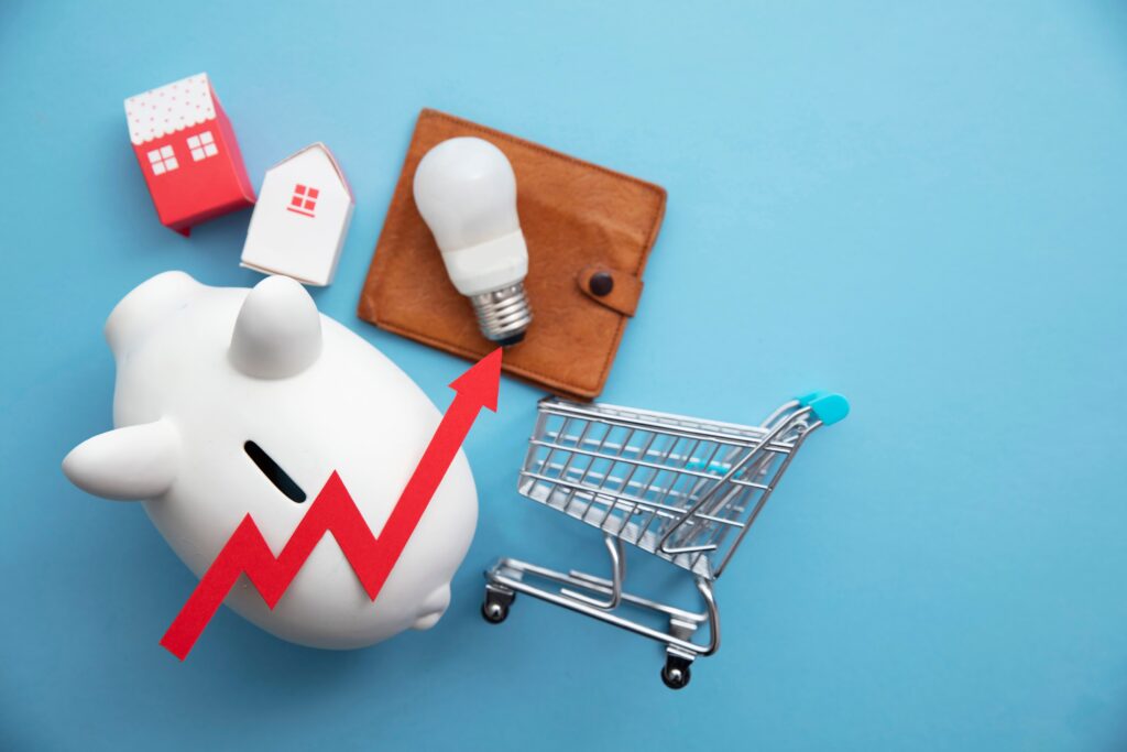 Piggy bank and shopping trolley on blue background