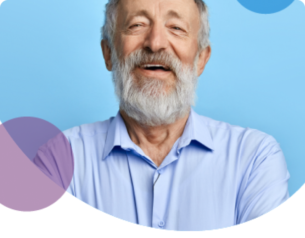 Elderly man smiling on light blue background
