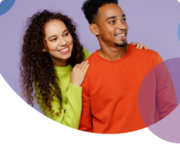 Couple smiling together wearing orange and green