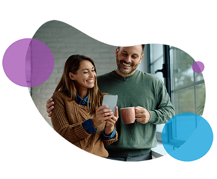 Couple smiling and holding mugs on white background with abstract shapes