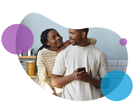 Couple smiling together on white background with abstract shapes