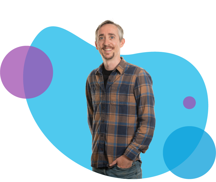 Man in blue, yellow, and black checkered shirt smiling