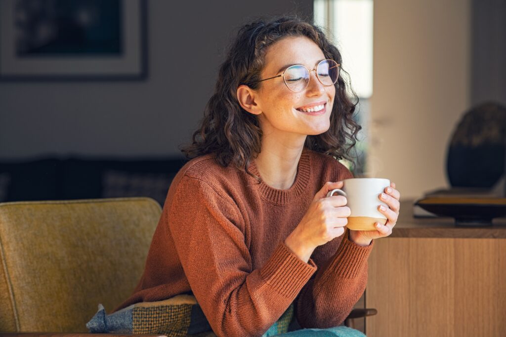 Woman holding mug and smiling