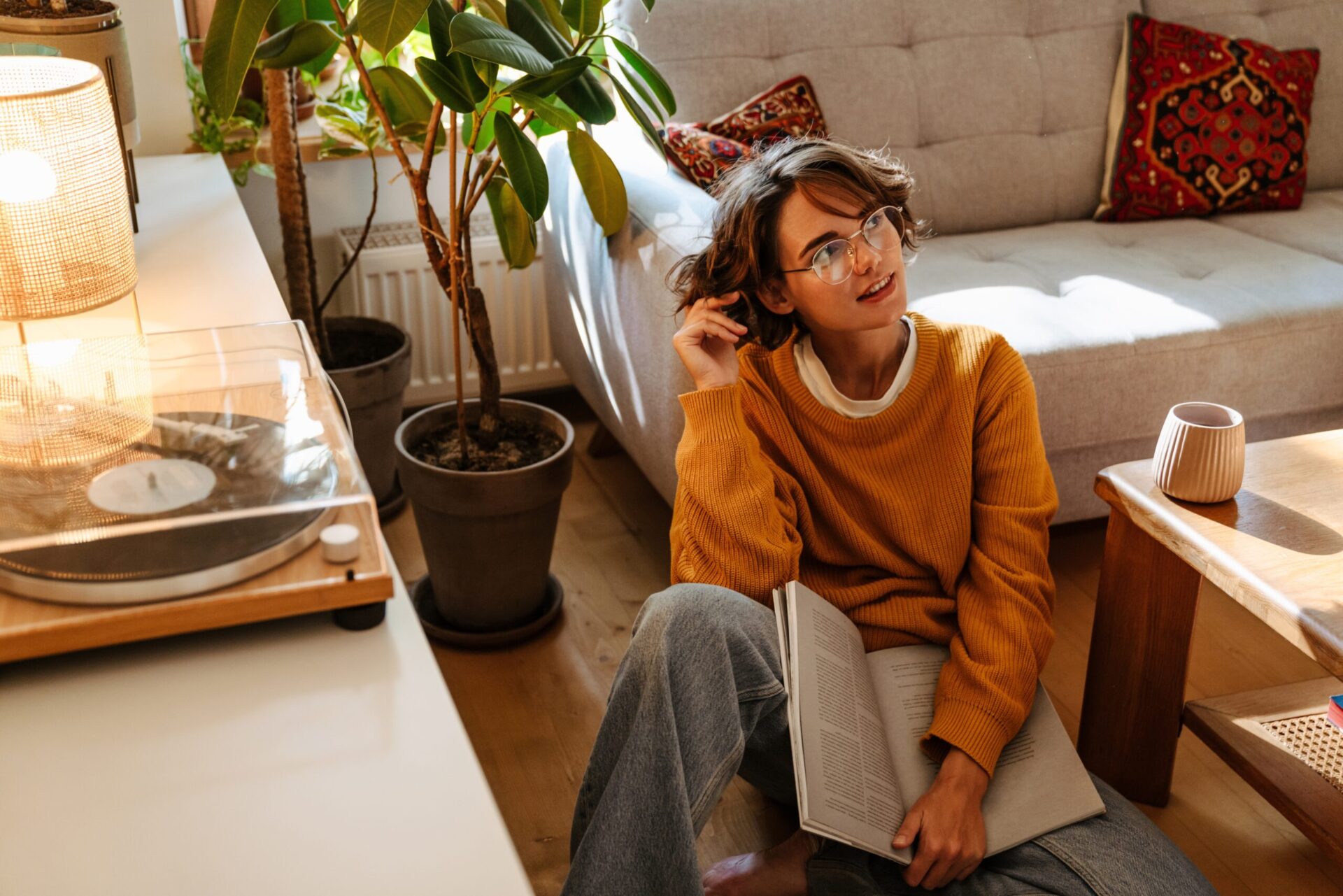 Young woman sitting on a lounge floor by a coffee table