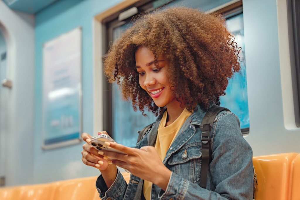 Woman smiling while texting on phone