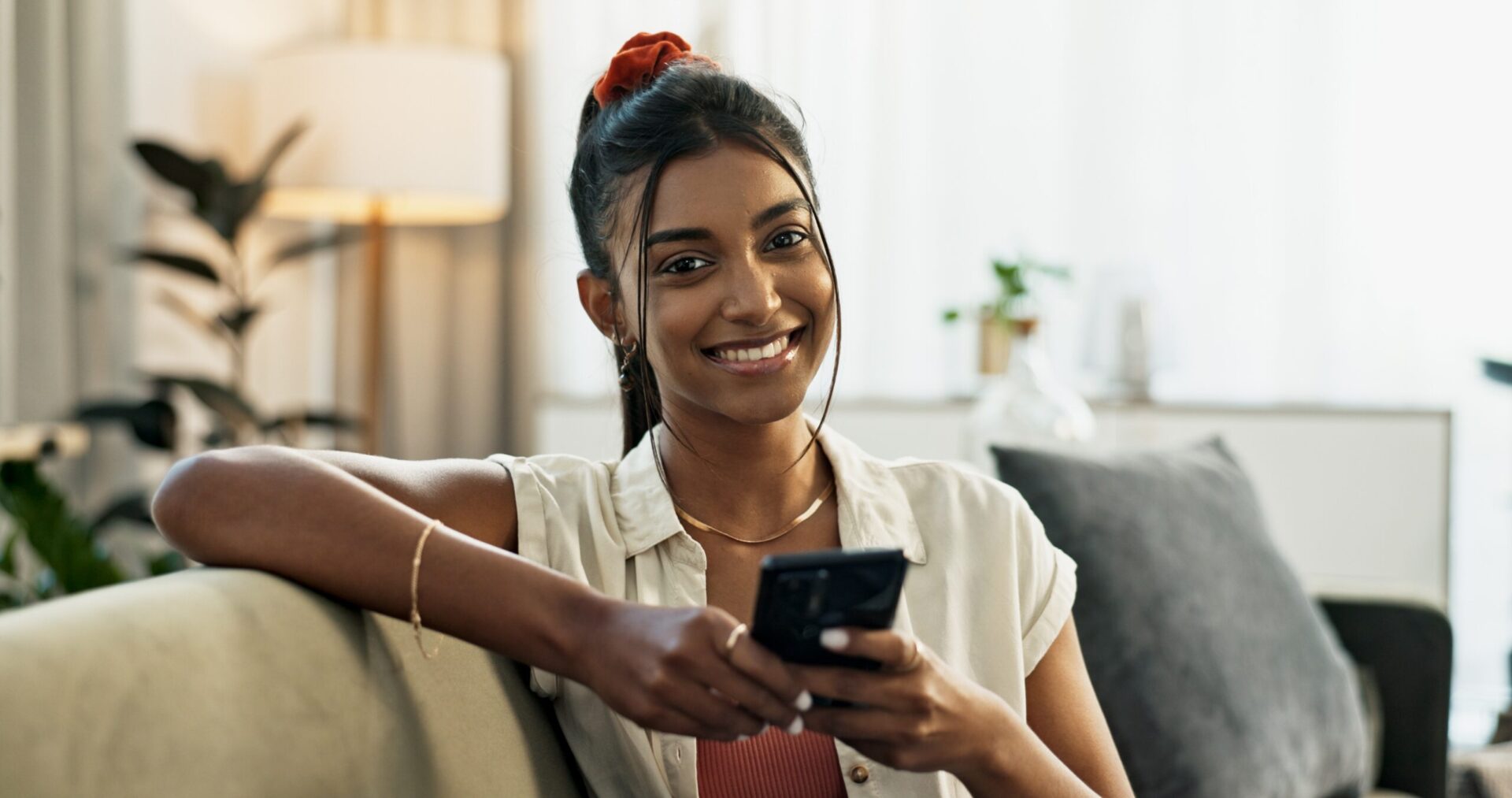 Woman smiling while using phone