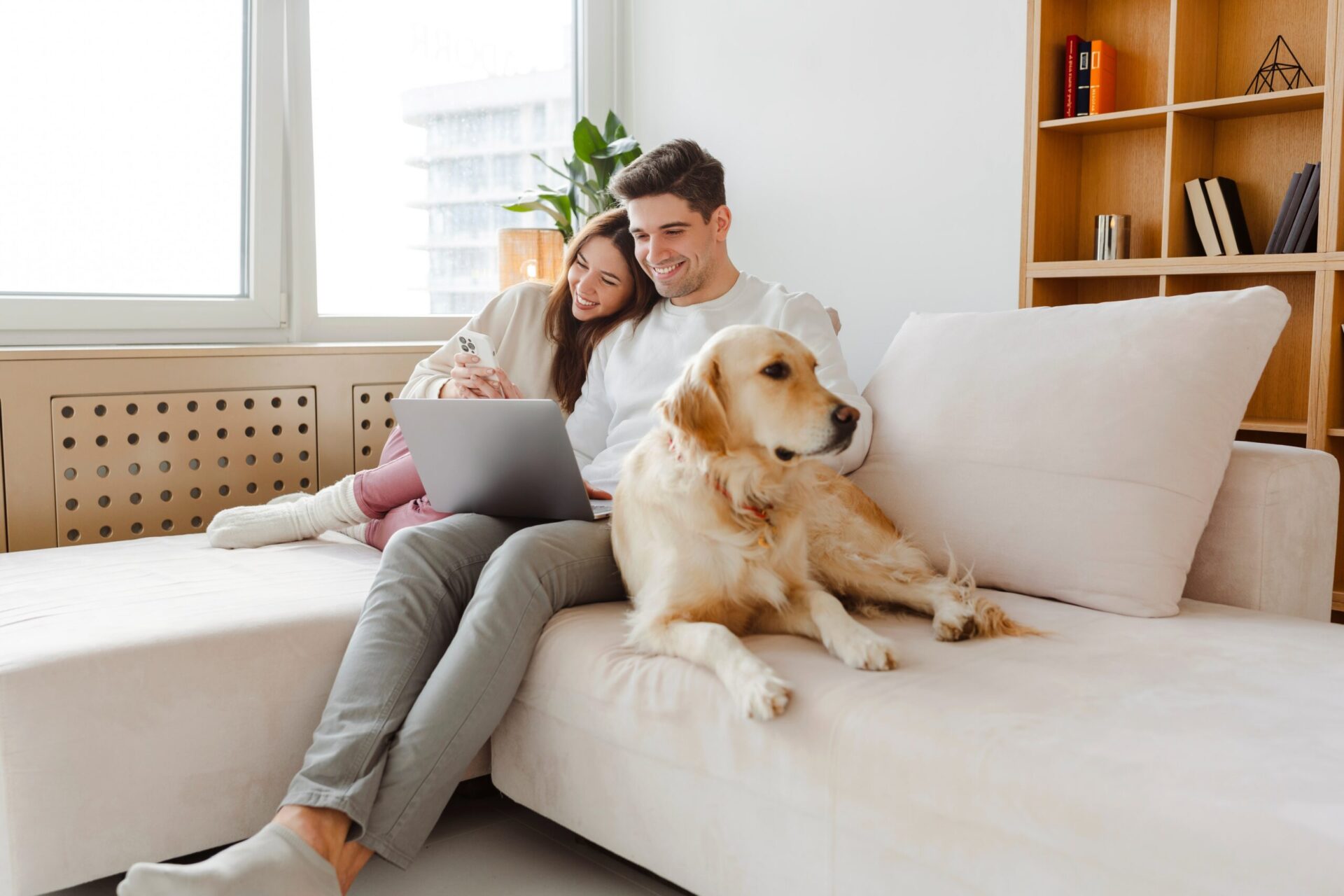 Couple relaxing on couch with dog