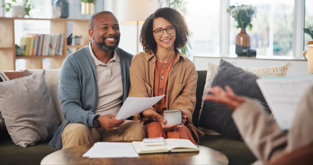 Couple discussing documents on couch