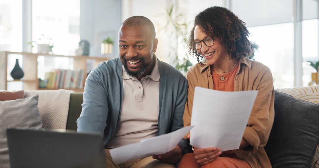 Woman showing man paperwork and smiling