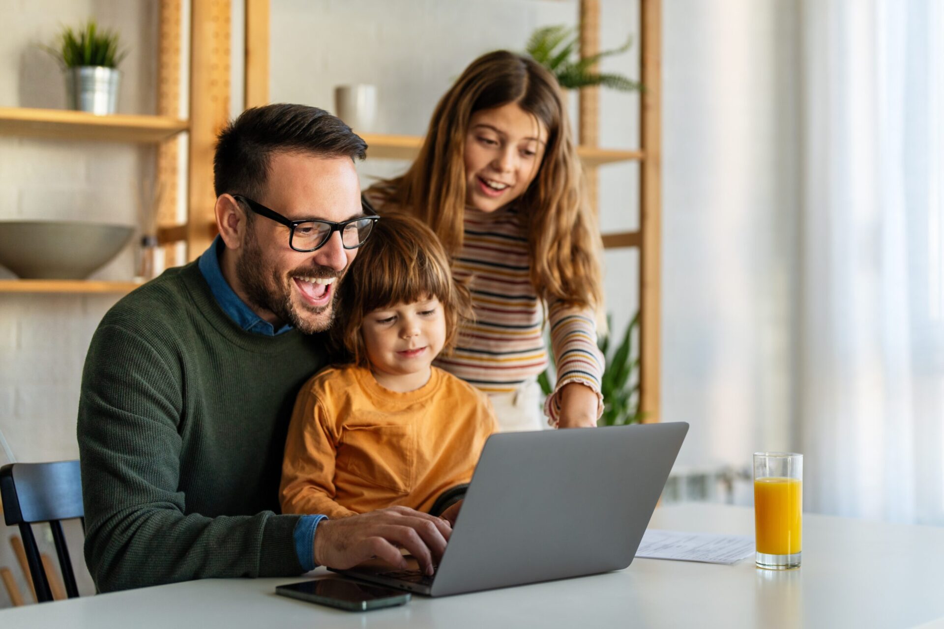 Family using laptop together at home