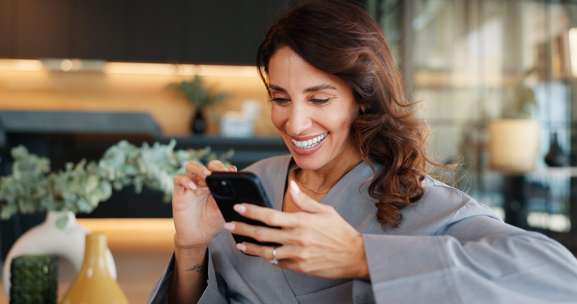 Smiling woman using smartphone